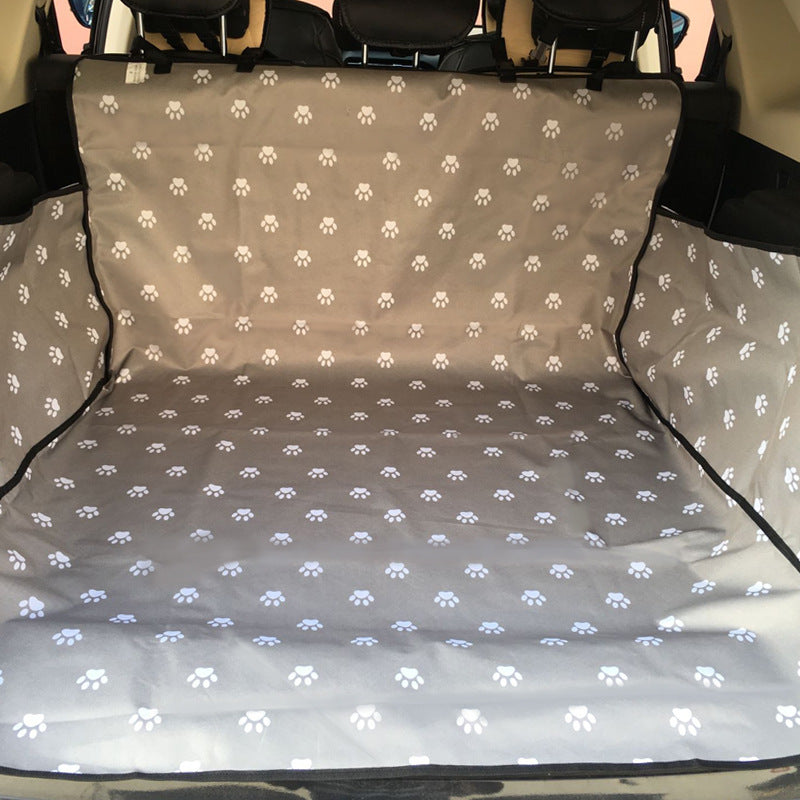 Car seat protector liner, gray with white paw-print pattern and black trim.