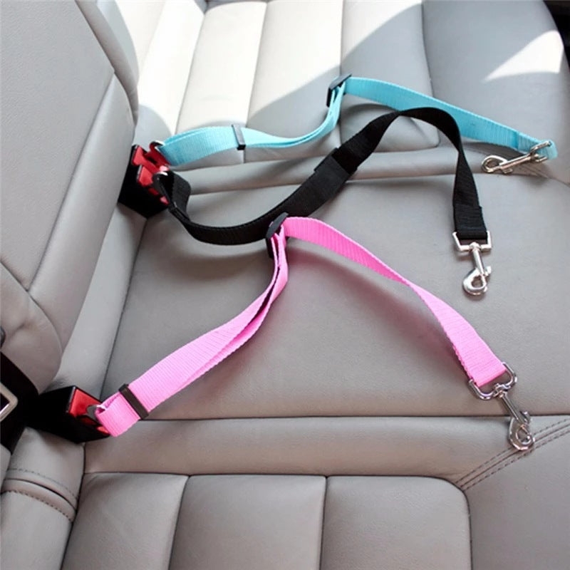 Adjustable pet car seat belt straps in blue, black, and pink with metal hooks