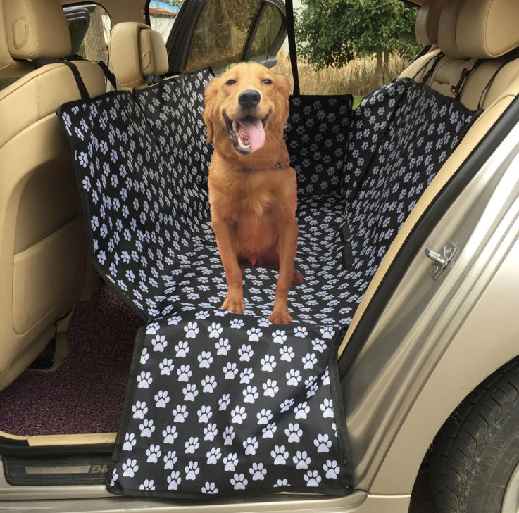 Car seat protector cover, black with white paw-print pattern for rear seats.