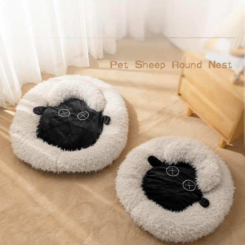 Two round plush pet beds with black sheep face applique on light beige faux fur