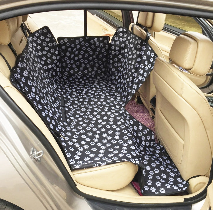 Car seat protector cover, black with white paw-print pattern for rear seating.