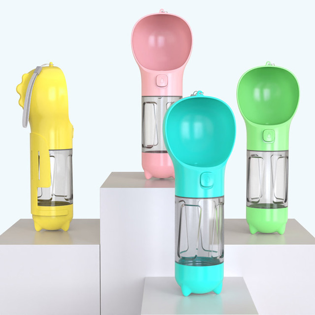 Portable dog water bottle in yellow, pink, and green with food cup and food box