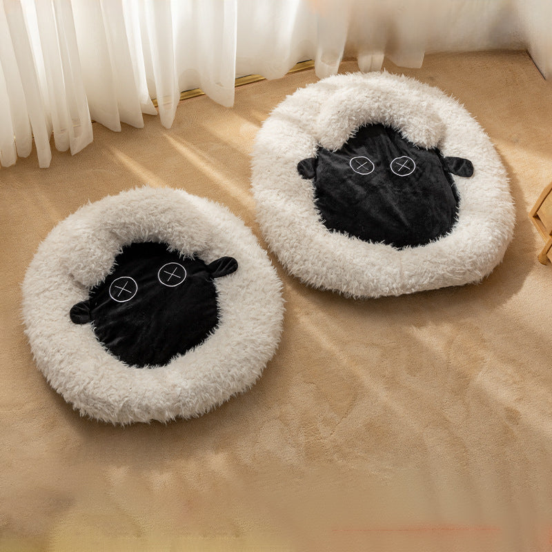Two round plush pet beds with black sheep face applique on light beige faux fur